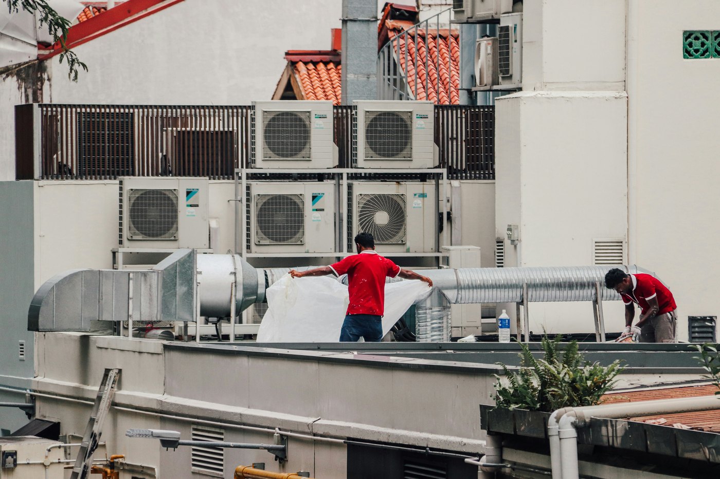 Technicians working around air conditioning units during an installation